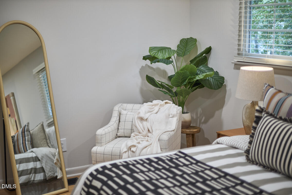 2613 McNeil Street, Unit B Raleigh, NC 27608 - Photo 23 of 31 a bedroom with a bed and a potted plant