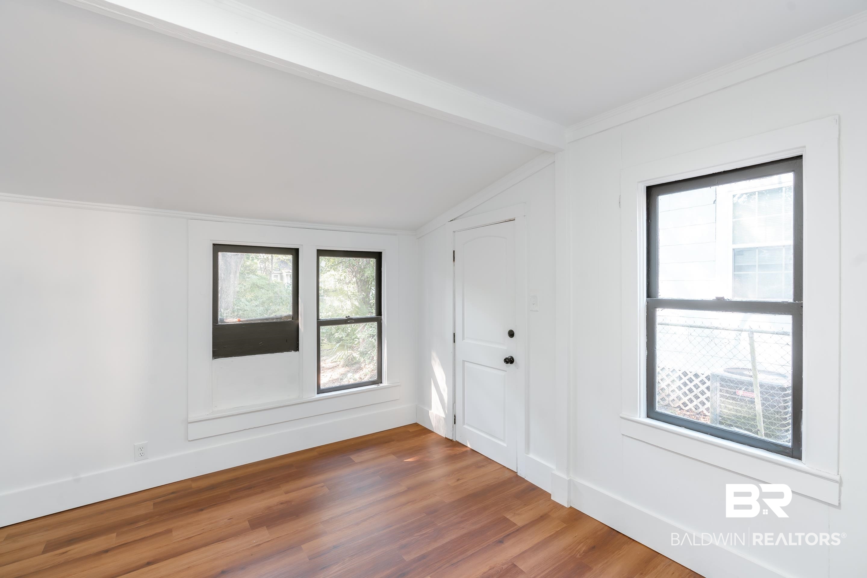 166 Crenshaw Street Mobile, AL 36606 - Photo 10 of 24 Unfurnished room with dark wood-type flooring, crown molding, and vaulted ceiling with beams