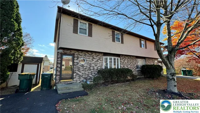 a view of a house with a yard
