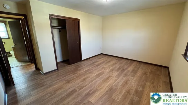 a view of hallway with wooden floor
