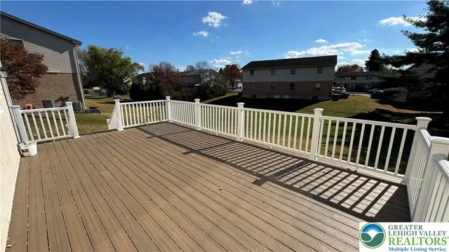 a view of balcony with wooden floor and fence