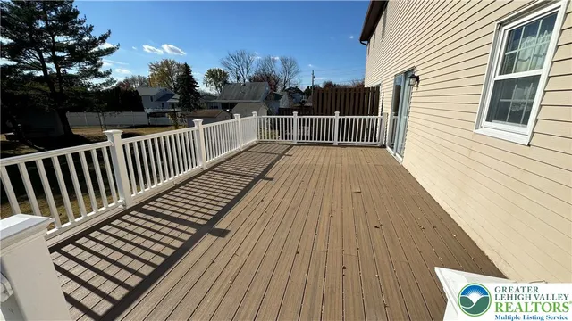 a view of balcony with wooden floor and fence