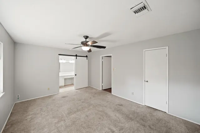 a view of a livingroom with a ceiling fan and window