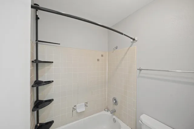 a bathroom with a shower and a toilet