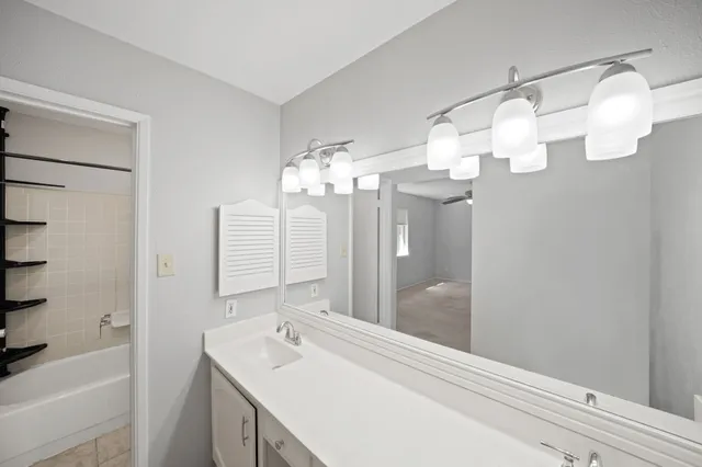 a bathroom with a sink a mirror and a bathtub