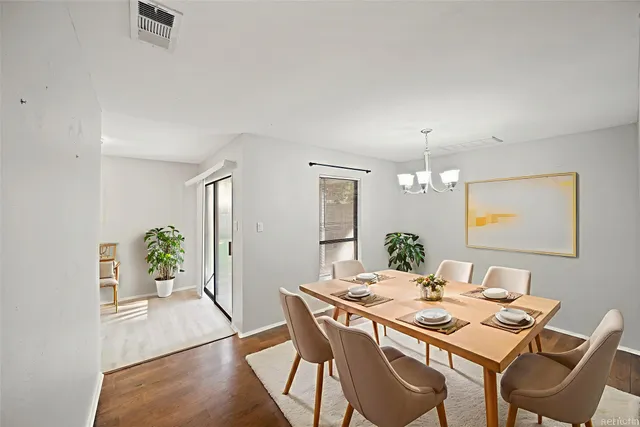 a view of a dining room that has a table and chairs