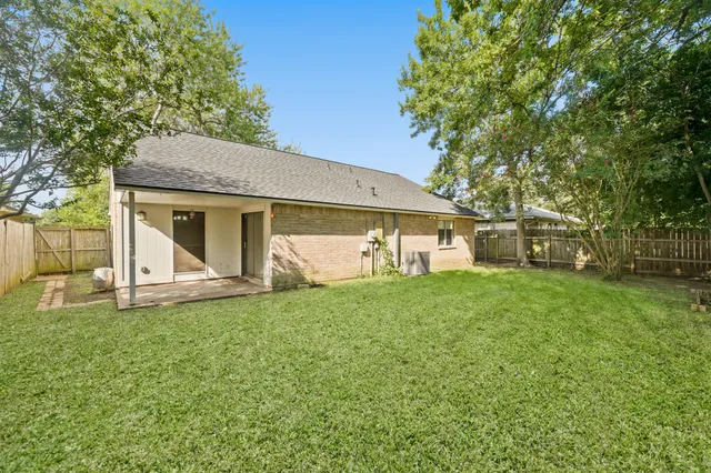 a front view of a house with a garden and yard