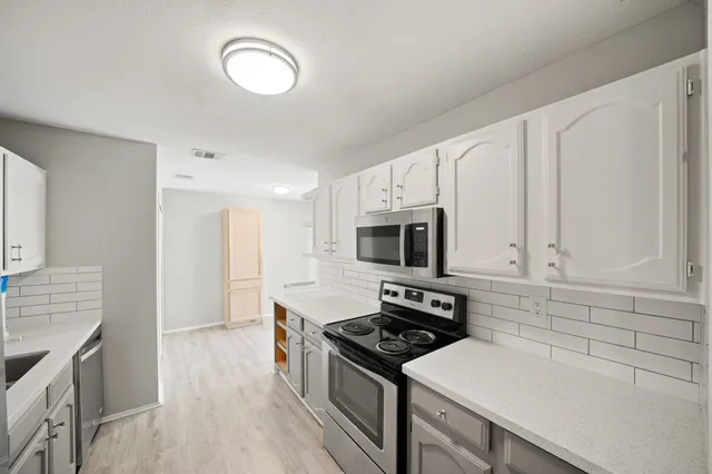 a kitchen with a stove and a microwave