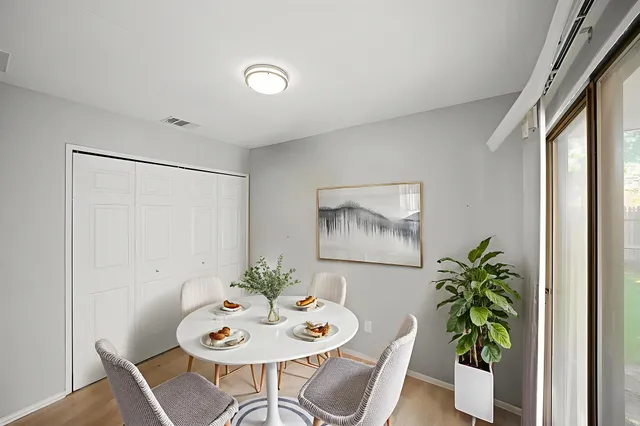 a view of a dining room with furniture window and wooden floor