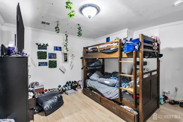 a bedroom with furniture and a chandelier
