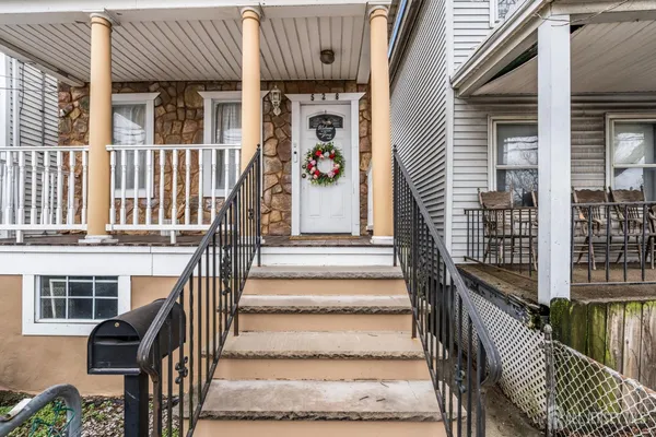 a front view of a house with entryway and stairs