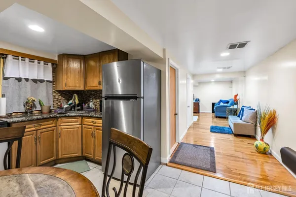 a kitchen with stainless steel appliances granite countertop a refrigerator and a sink