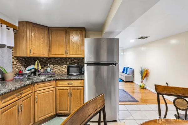 a kitchen with stainless steel appliances granite countertop a refrigerator sink and cabinets