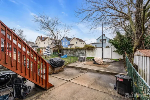 a view of a house with a chairs in a patio