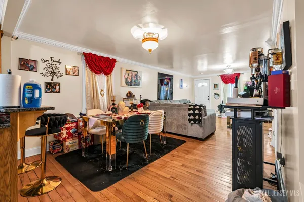 a living room with furniture a flat screen tv and a table