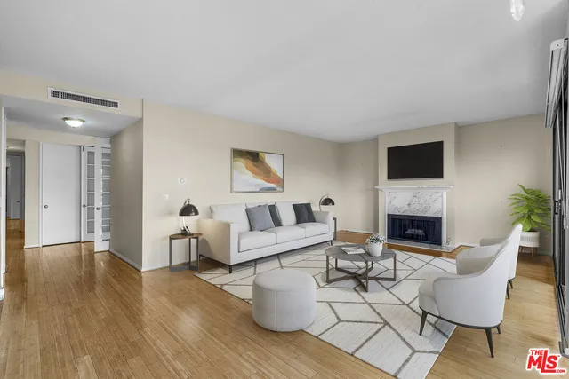 a living room with furniture a fireplace and a potted plant