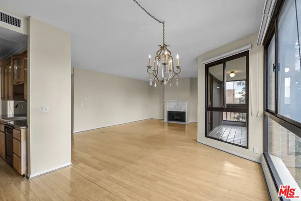 a view of an empty room with a chandelier