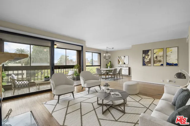 a living room with furniture and a floor to ceiling window