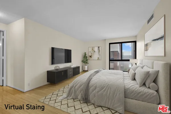a bedroom with a large bed and a flat screen tv