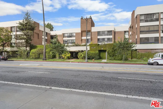 a view of a street with a building in the background