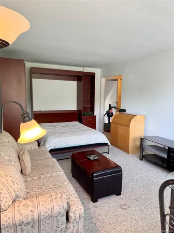 a bedroom with bed and a window