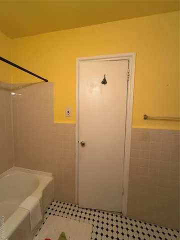 a bathroom with a bathtub and shower