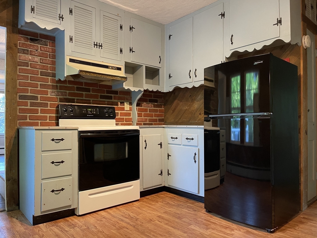 35 Iowa Street Worcester, MA 01602 - Photo 12 of 25 a kitchen with stainless steel appliances a stove and a refrigerator