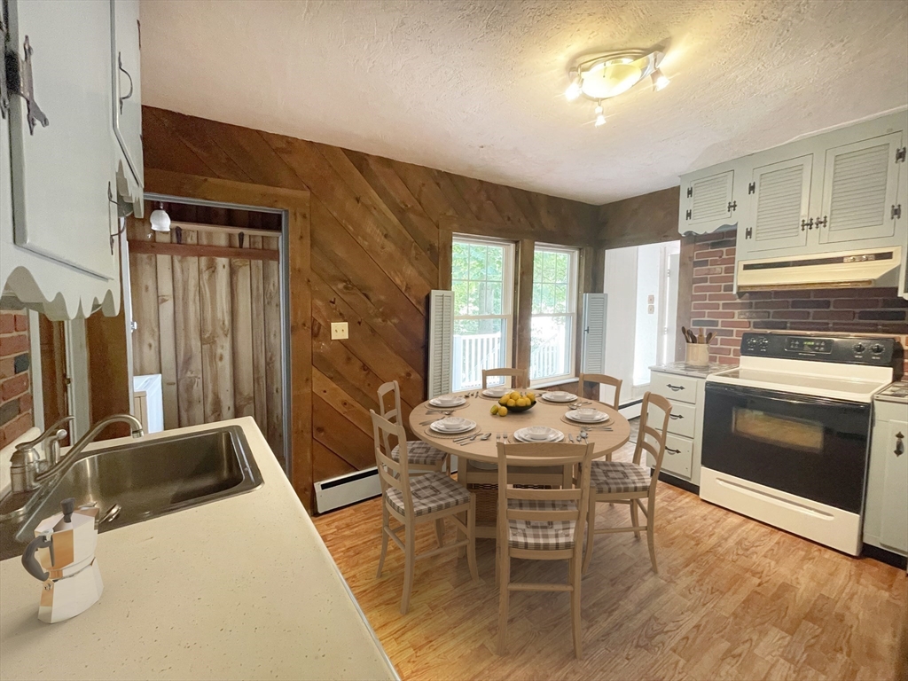 35 Iowa Street Worcester, MA 01602 - Photo 4 of 25 a kitchen with a stove a sink and a refrigerator