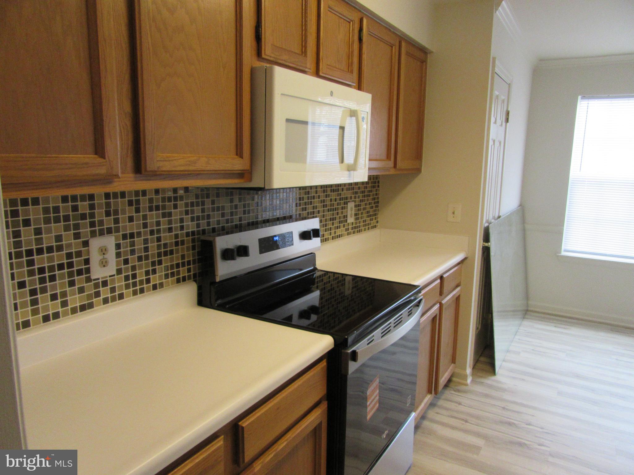 11006 Koman Circle, Unit 104 Manassas, VA 20109 - Photo 11 of 39 Brand new electric stove in kitchen