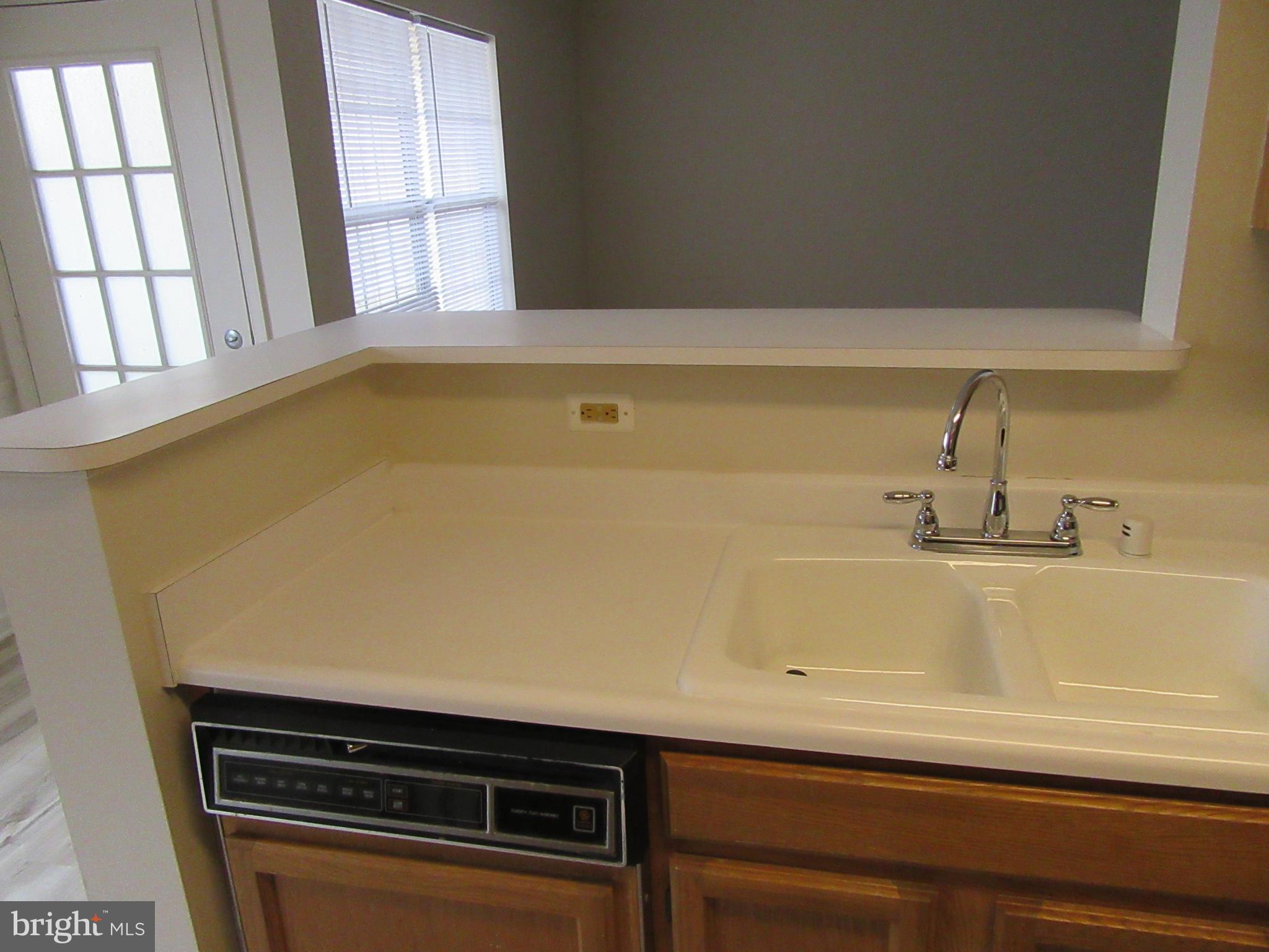 11006 Koman Circle, Unit 104 Manassas, VA 20109 - Photo 10 of 39 Kitchen counter bar into living room