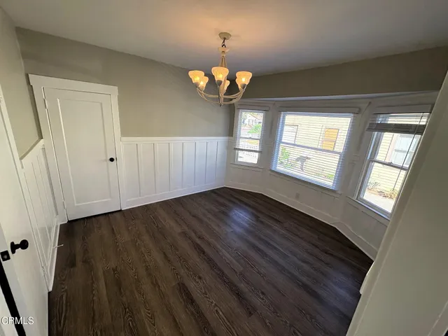 a view of a livingroom with a fireplace wooden floor and window