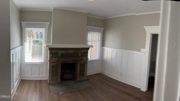 a view of a livingroom with an empty space and wooden floor