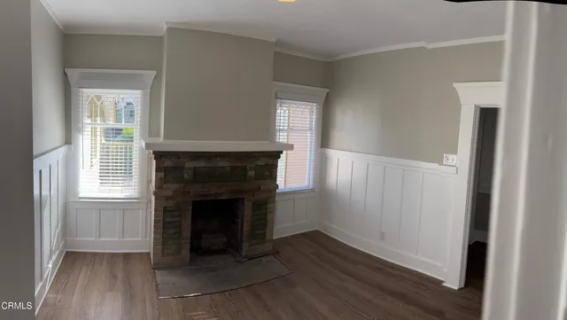 a view of a livingroom with an empty space and wooden floor
