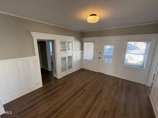 a view of a hallway with wooden floor