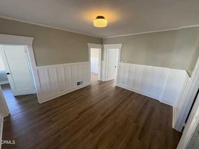 a view of hallway with wooden floor