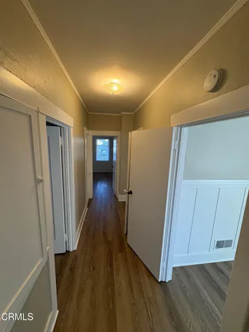 a view of gallery with wooden floor