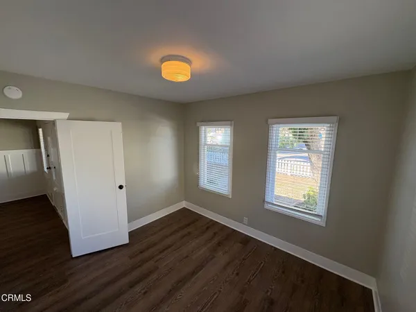 a view of hallway with stairs and wooden floor