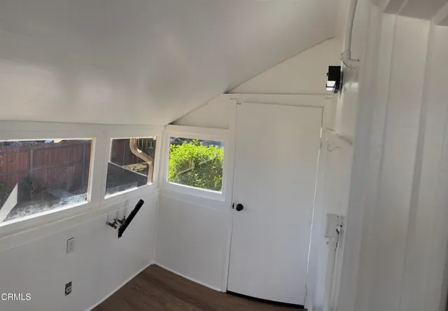 a view of balcony with wooden floor and potted plant