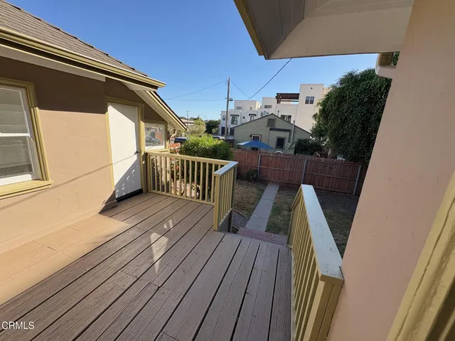 a view of balcony with wooden floor and stairs