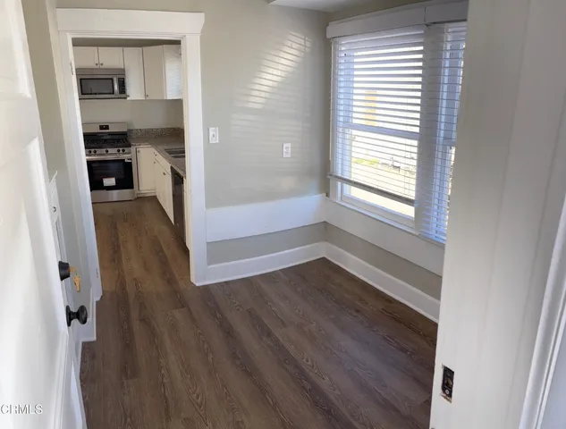 a view of hallway with wooden floor