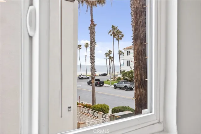 an empty room with wooden floor ceiling fan and windows