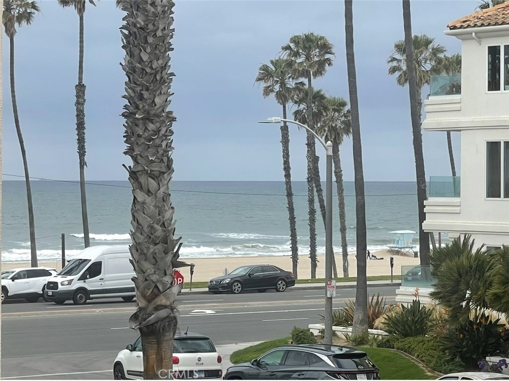 114 10th Street, Unit C Huntington Beach, CA 92648 - Photo 12 of 21 a view of a street with cars parked in front of a house
