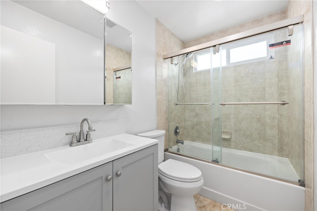 114 10th Street, Unit C Huntington Beach, CA 92648 - Photo 15 of 21 a bathroom with a sink mirror toilet and bathtub