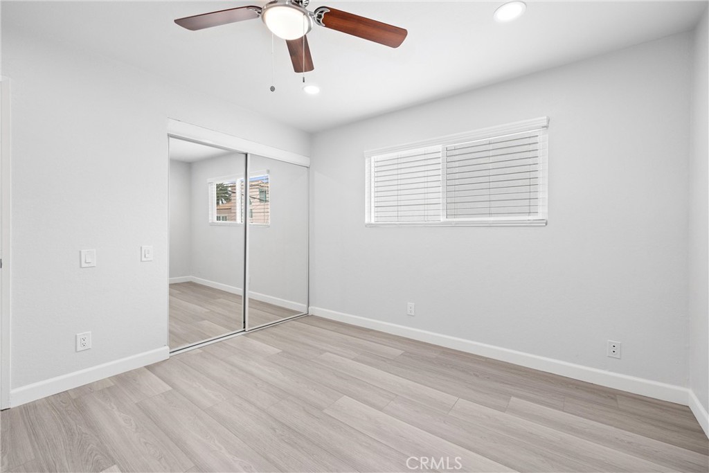 114 10th Street, Unit C Huntington Beach, CA 92648 - Photo 16 of 21 wooden floor in an empty room with a window