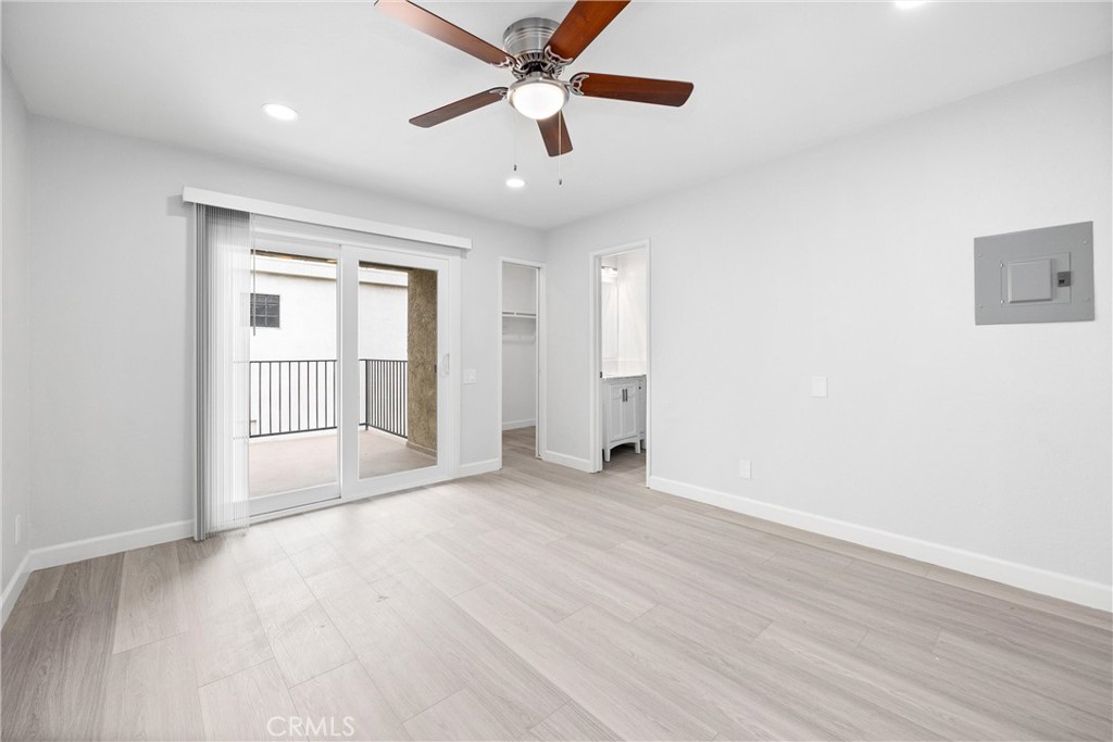 114 10th Street, Unit C Huntington Beach, CA 92648 - Photo 20 of 21 an empty room with wooden floor ceiling fan and windows
