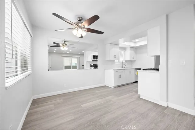 a view of a kitchen with a sink cabinets and wooden floor
