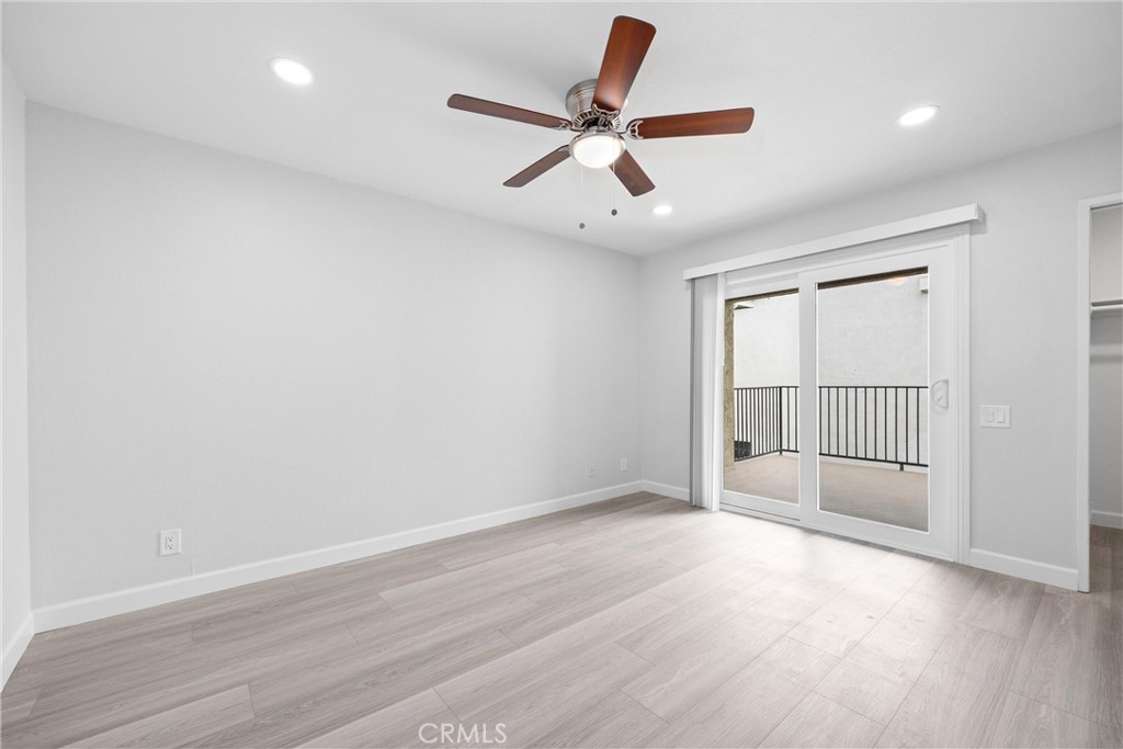 114 10th Street, Unit C Huntington Beach, CA 92648 - Photo 21 of 21 an empty room with wooden floor and windows