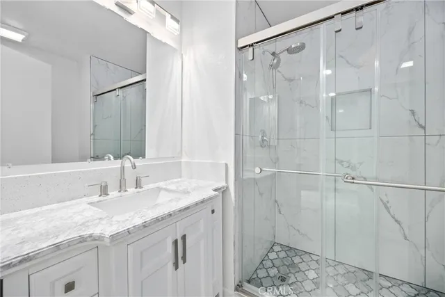 an empty room with wooden floor ceiling fan and windows