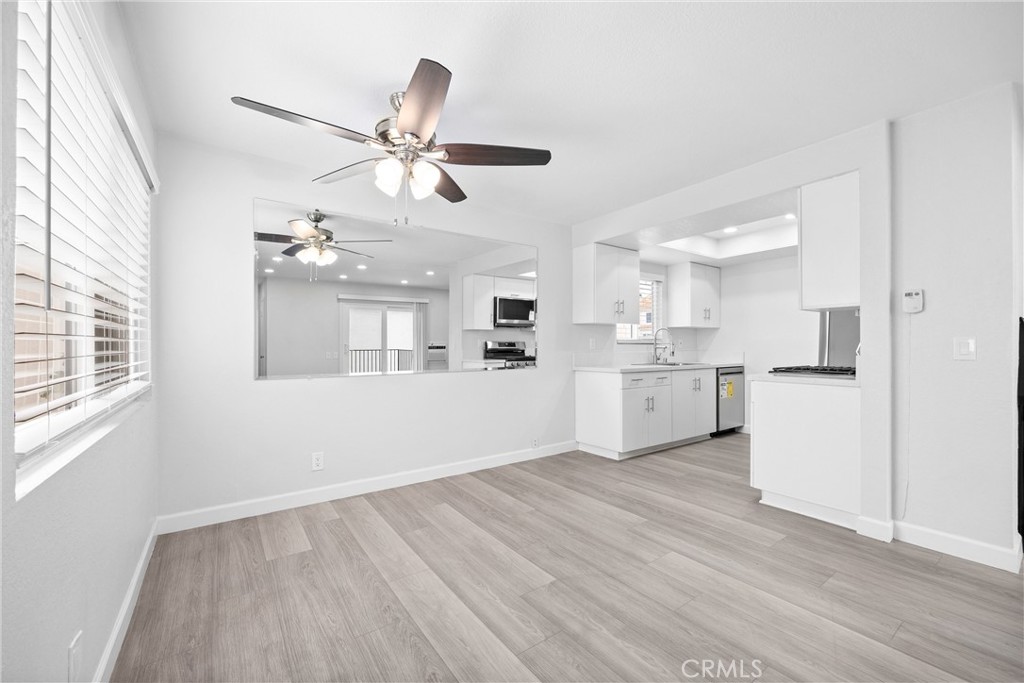114 10th Street, Unit C Huntington Beach, CA 92648 - Photo 5 of 21 a view of a kitchen with wooden floor and a kitchen