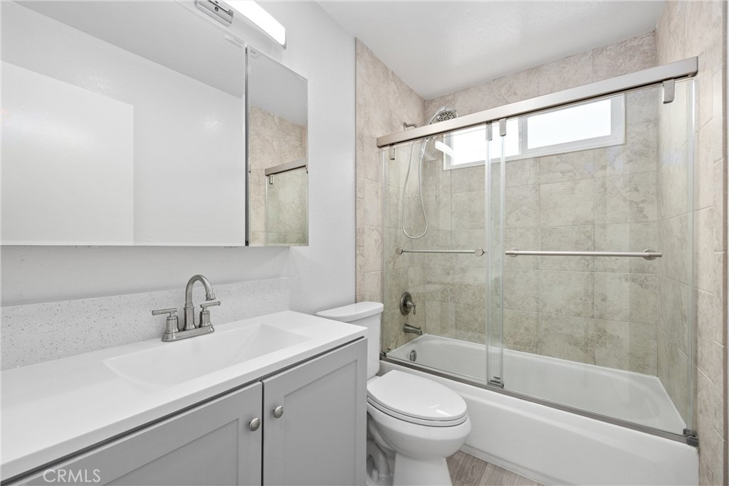 114 10th Street, Unit C Huntington Beach, CA 92648 - Photo 7 of 21 a bathroom with a sink mirror bathtub and toilet